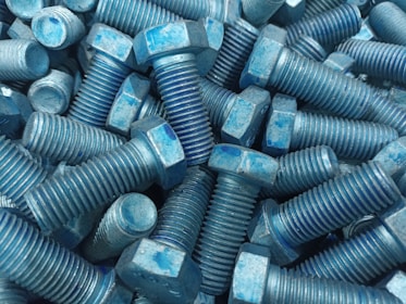 Finished bolts neatly stacked after passing through the trimming process | Samrat