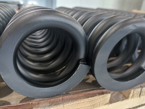 Various custom springs displayed on a workshop table.