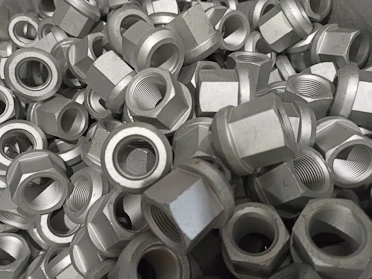 Detailed photo of heavy-duty hex bolts stacked in bulk.