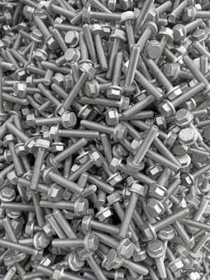 A vibrant display of colorful screws and bolts arranged in a spiral pattern