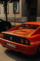 A sleek red Ferrari parked on a city street at sunset, reflecting luxury and speed.