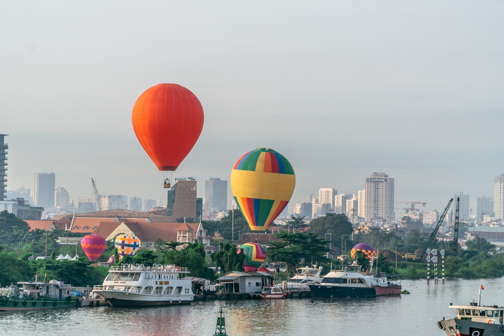 a group of hot air balloons flying over a body of water