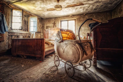 a room with a bed and a baby carriage in it