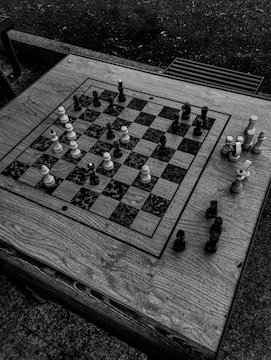 A stark black-and-white photo of a chessboard mid-game, highlighting a bold move.