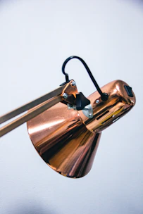 Metal lamp housing with smooth curves and a polished finish ready for assembly.