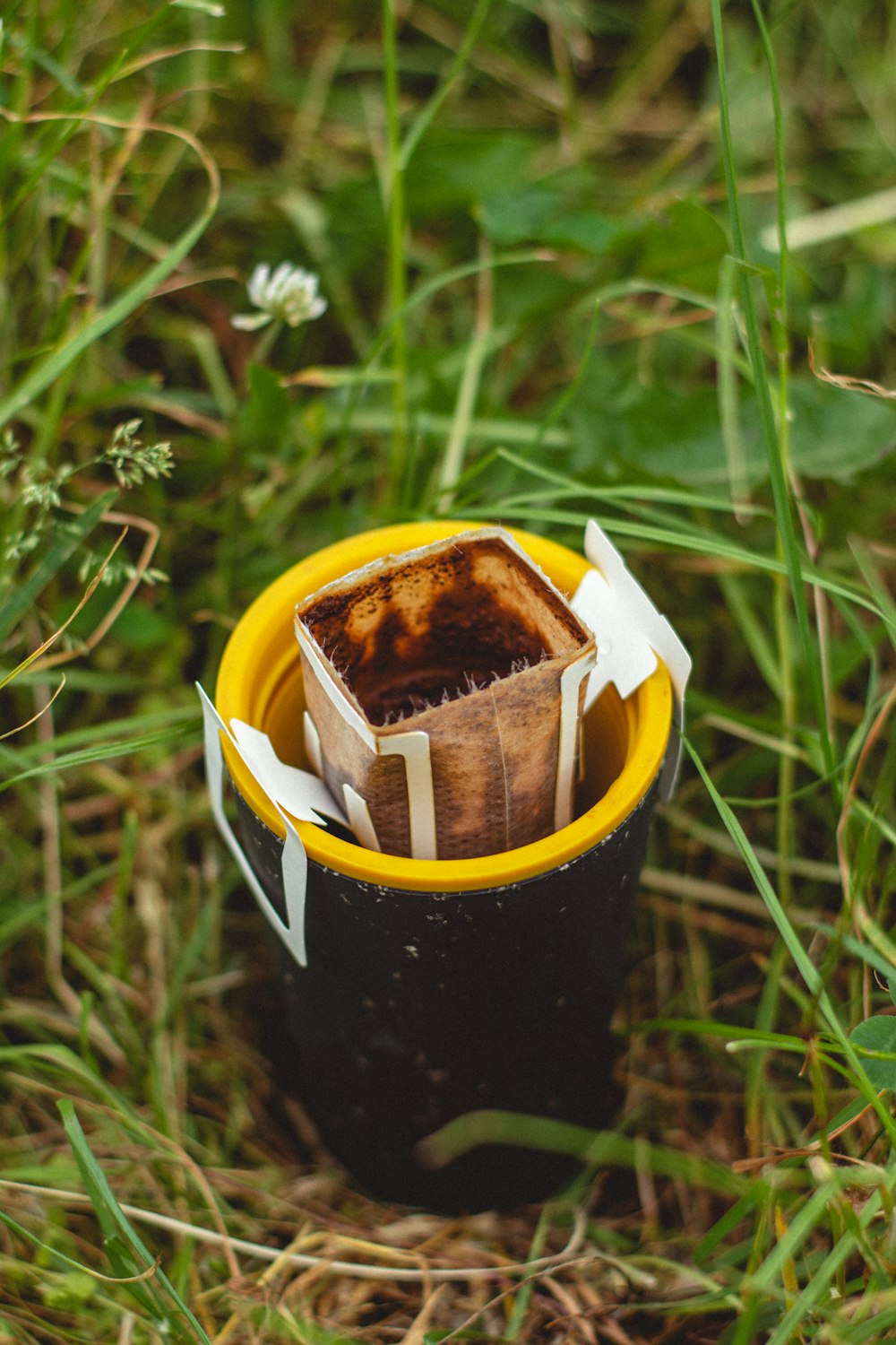 a cup that is sitting in the grass