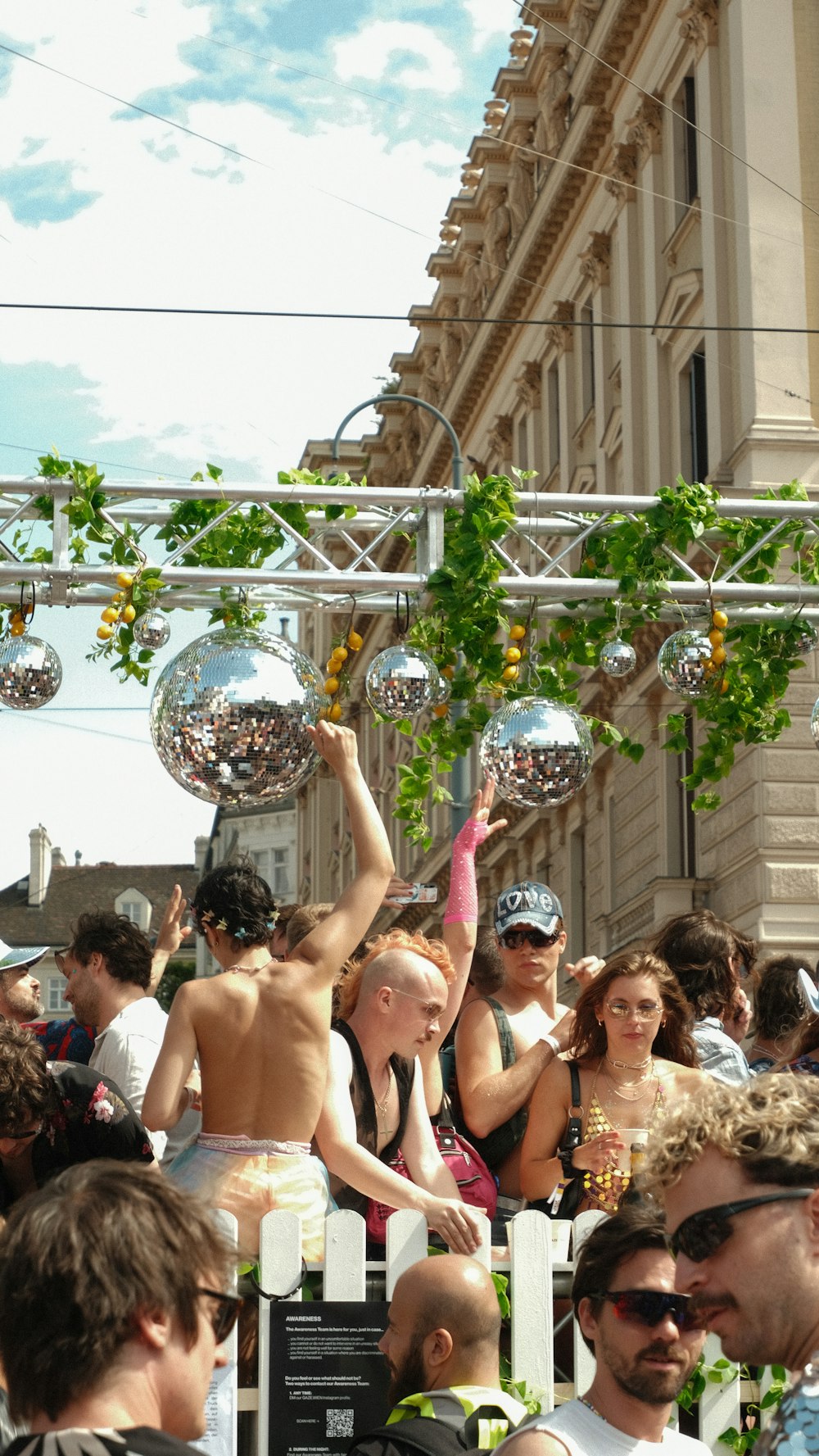 a crowd of people standing around each other in front of a building