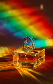 Close-up of a vibrant, prismatic ring catching light at different angles, showcasing its precise engineering and bold colors.