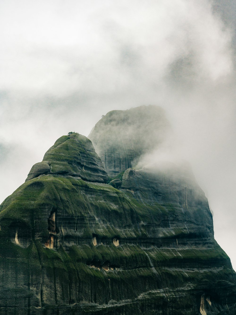 a very tall mountain covered in green moss