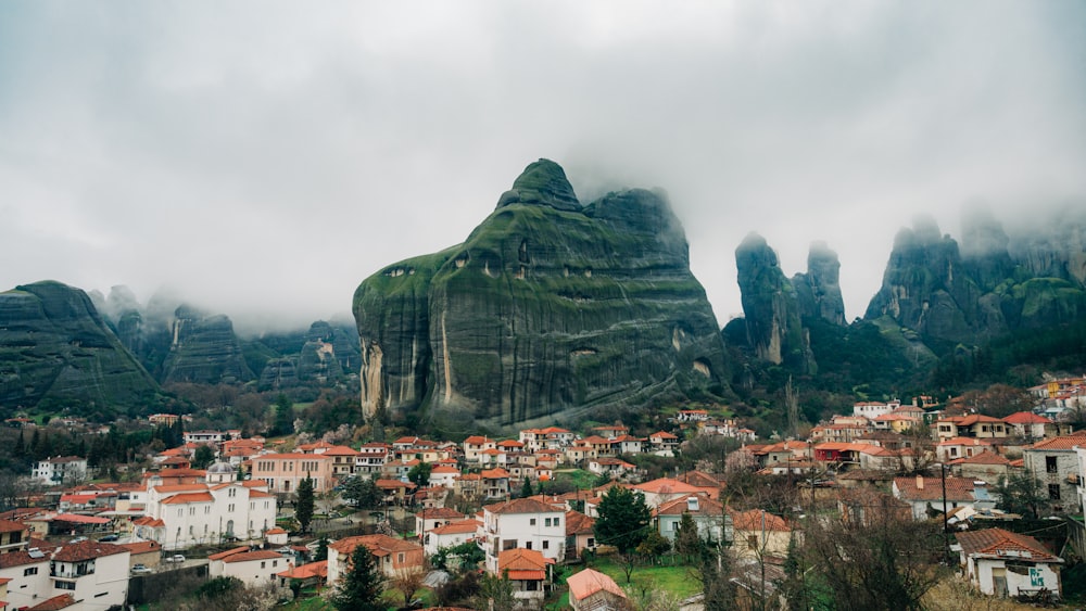 a small village in the mountains with a mountain in the background