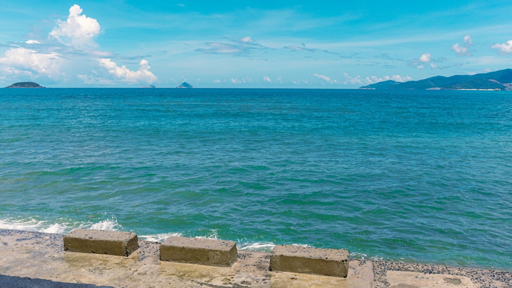 a couple of benches sitting on top of a stone wall