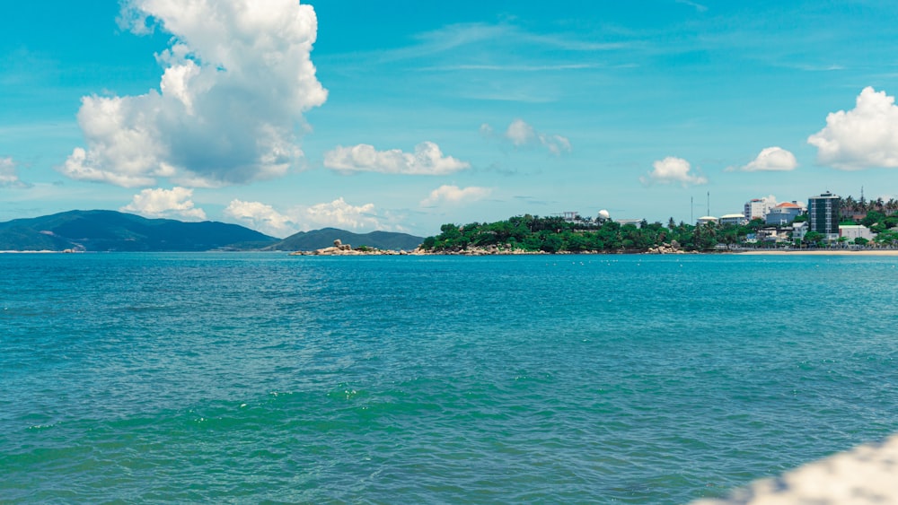 a body of water with a city in the background