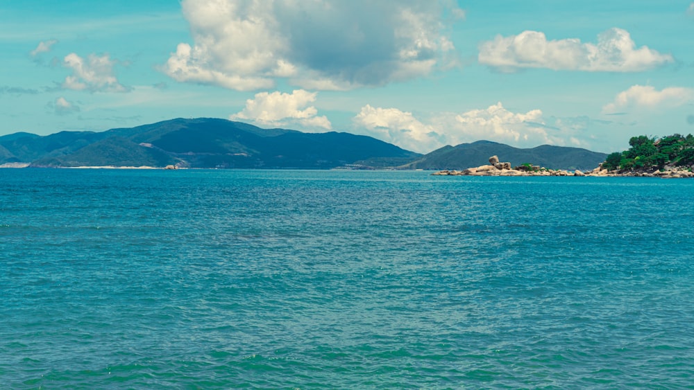 a large body of water with mountains in the background