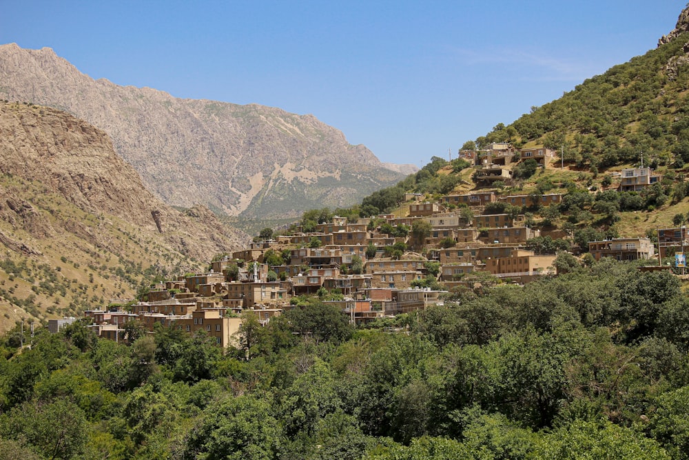 a village in the mountains with a mountain in the background