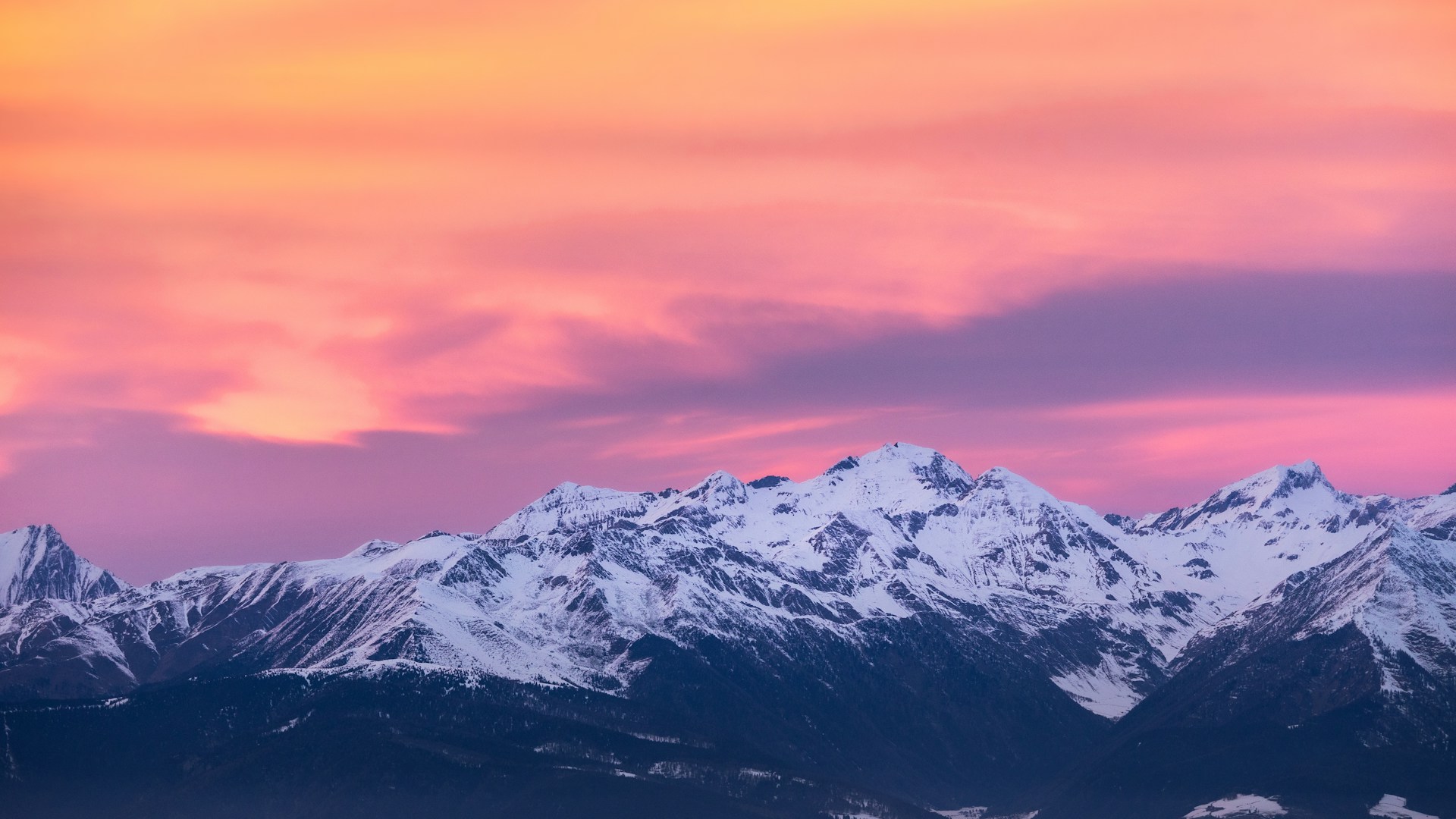 A stunning view of the crystal mountains against a sunset, showcasing vibrant orange and turquoise hues.