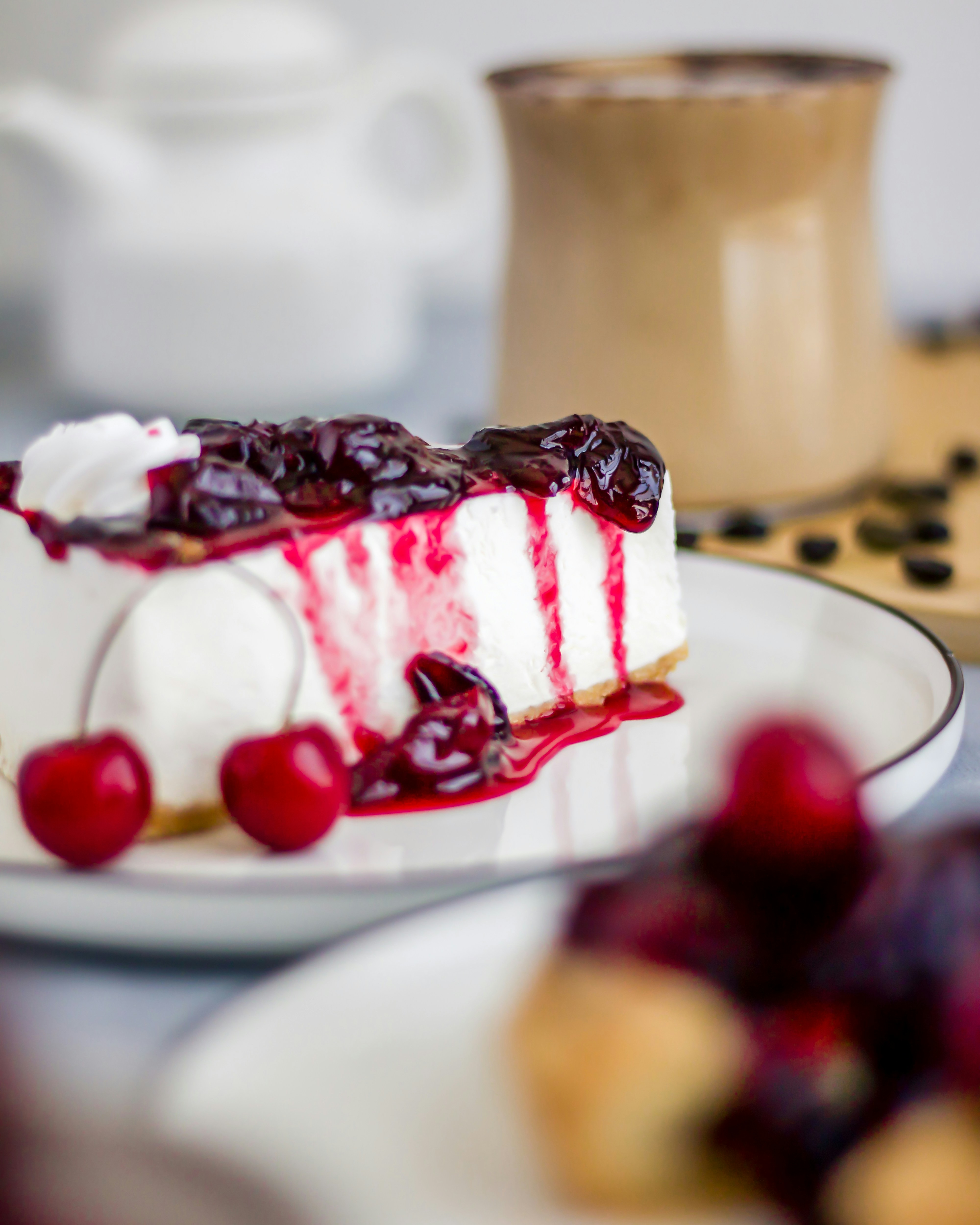 a slice of cheesecake with cherries on a plate
