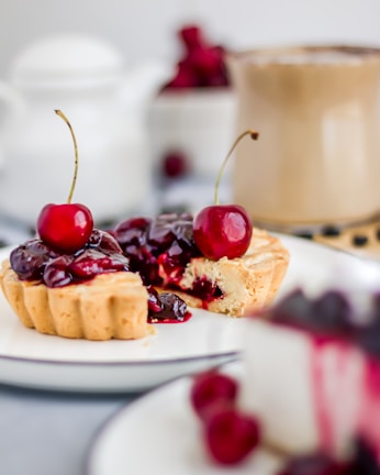 a small dessert with cherries on a plate