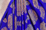Close-up of luxury textile threads from Spun Threads India in rich royal blue and gold hues.