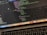 A close-up view of a laptop displaying code on the screen. The code editor is open on a dark-themed interface, showing lines of JavaScript with syntax highlighting. Below the screen, the keyboard of the laptop is partially visible. The laptop's dock at the bottom houses several application icons.