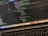 A close-up view of a laptop displaying code on the screen. The code editor is open on a dark-themed interface, showing lines of JavaScript with syntax highlighting. Below the screen, the keyboard of the laptop is partially visible. The laptop's dock at the bottom houses several application icons.
