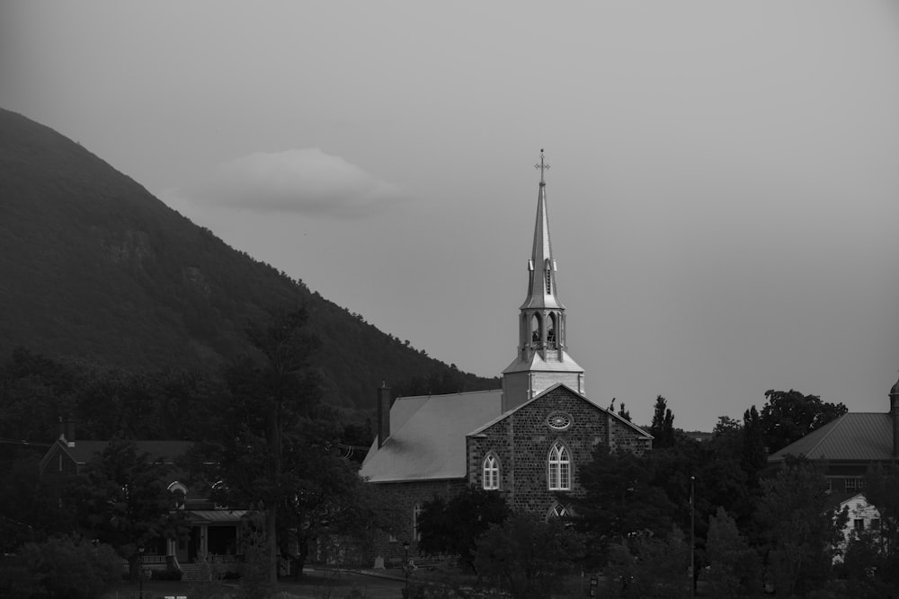 a black and white photo of a church with a steeple