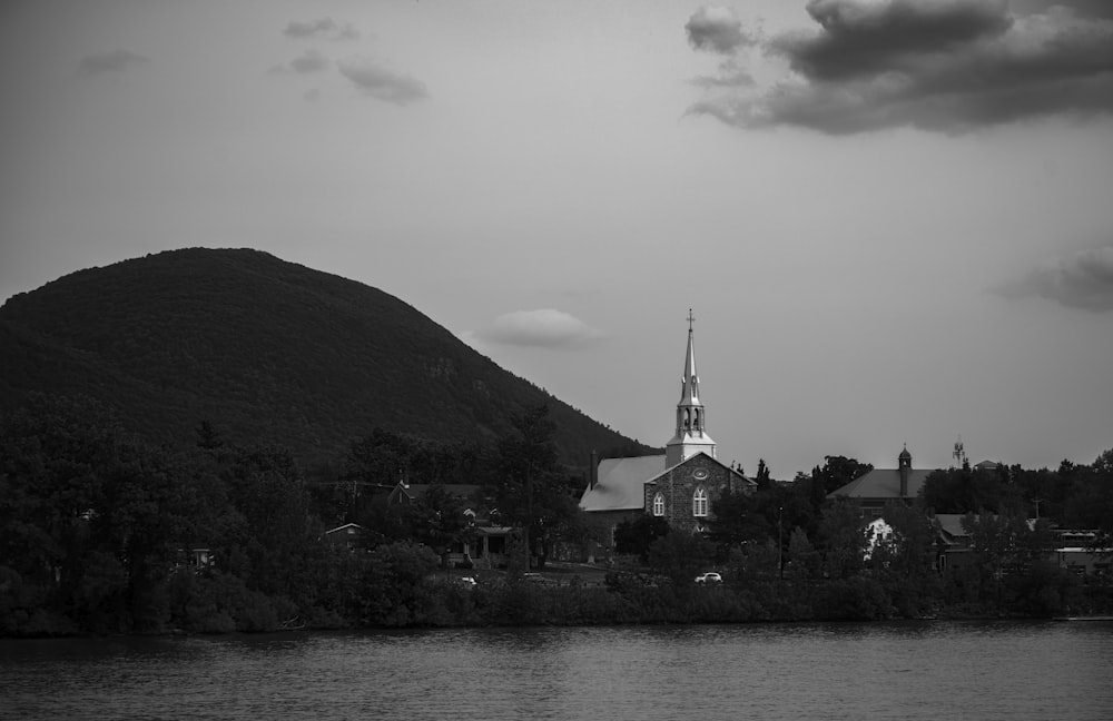 a black and white photo of a church on a hill