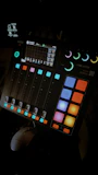 Mixing console with colorful lights reflecting creativity in the studio.