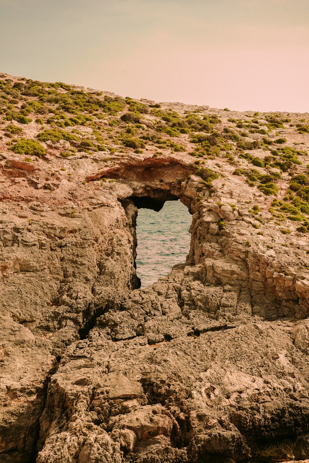 a rocky outcropping with a hole in the middle