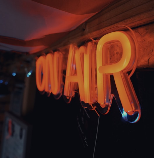 a neon sign hanging from the side of a wall