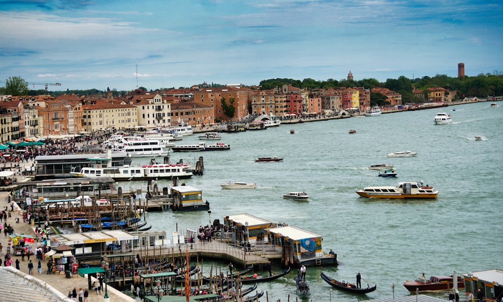 a harbor filled with lots of boats next to tall buildings