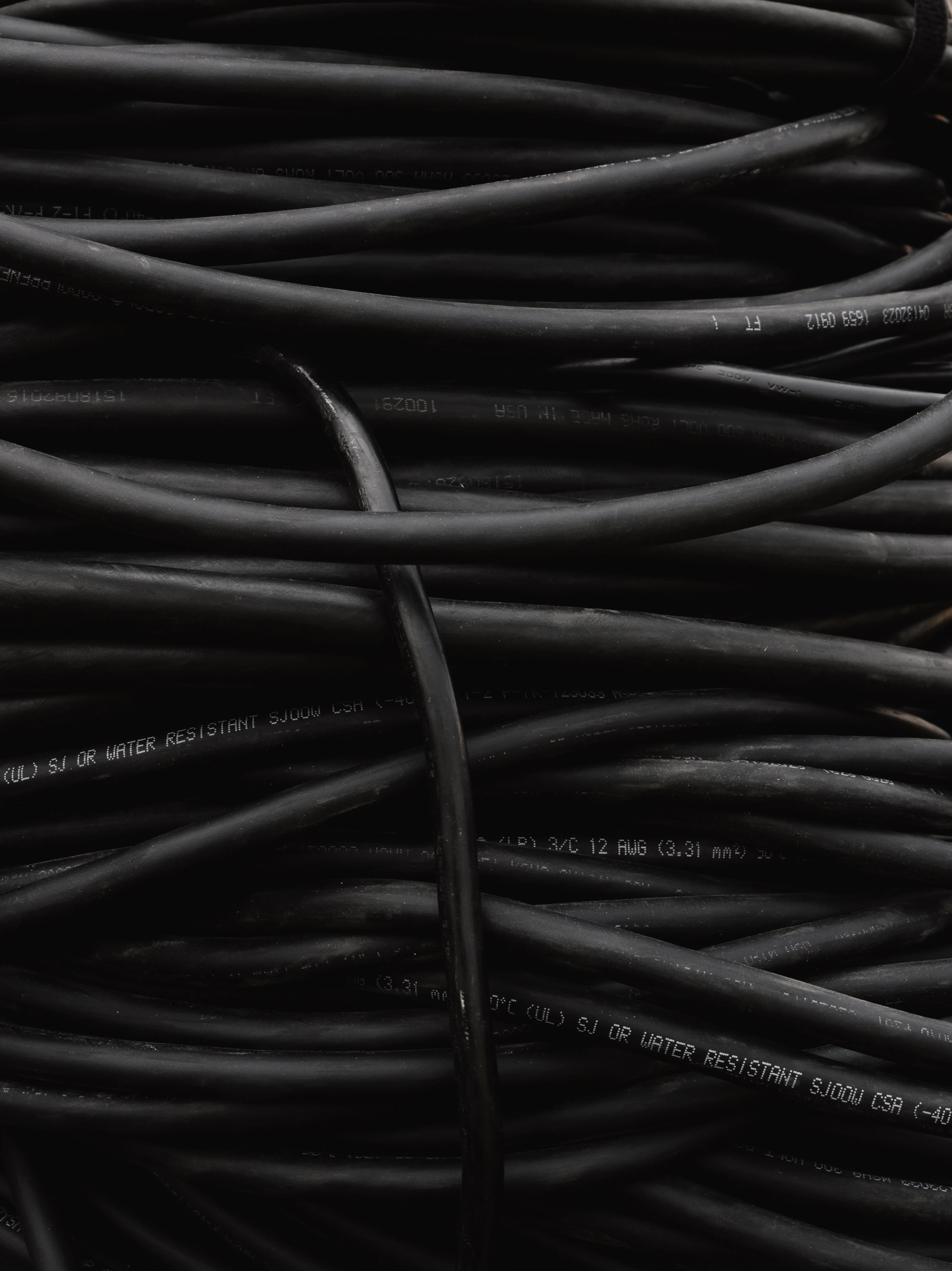 Bundle of black cables before being hidden in the wall