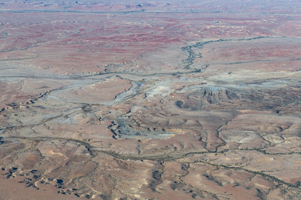 an aerial view of a desert with a river running through it