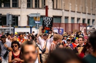 A group of diverse people wearing solidtees custom t-shirts at an outdoor event.