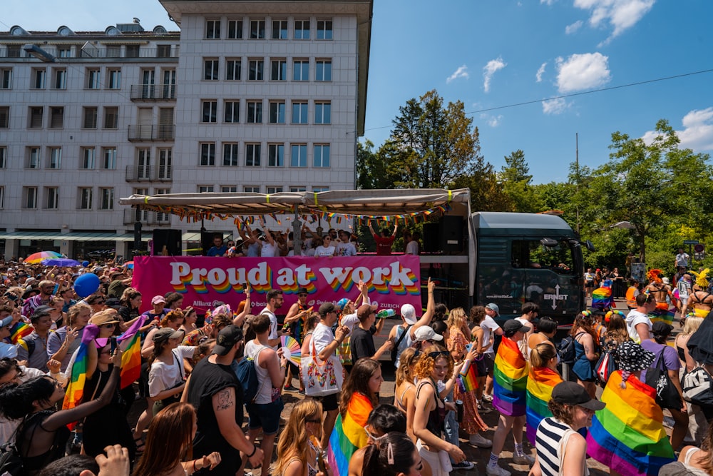 a crowd of people standing around a bus