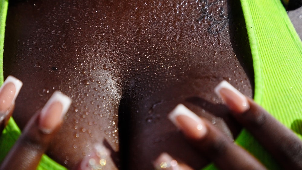 a close up of a woman's body with her hands on her chest