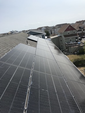 Rooftop installation of Rescomm Solar panels on a sunny suburban home.