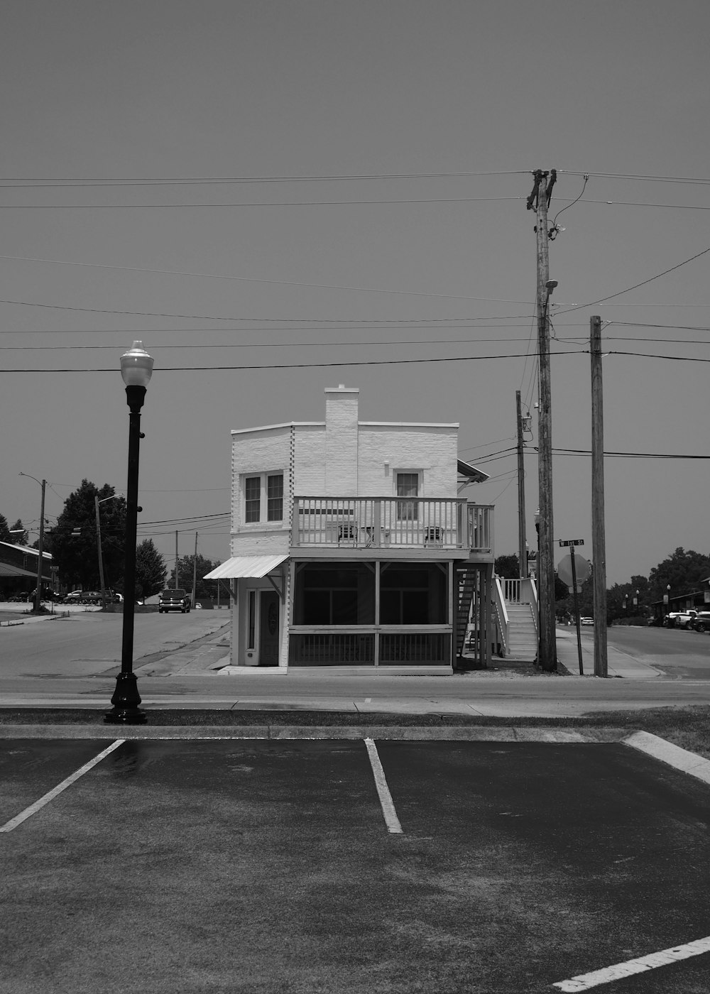 a black and white photo of a street corner