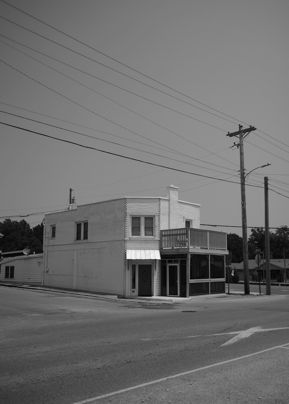 a black and white photo of a street corner