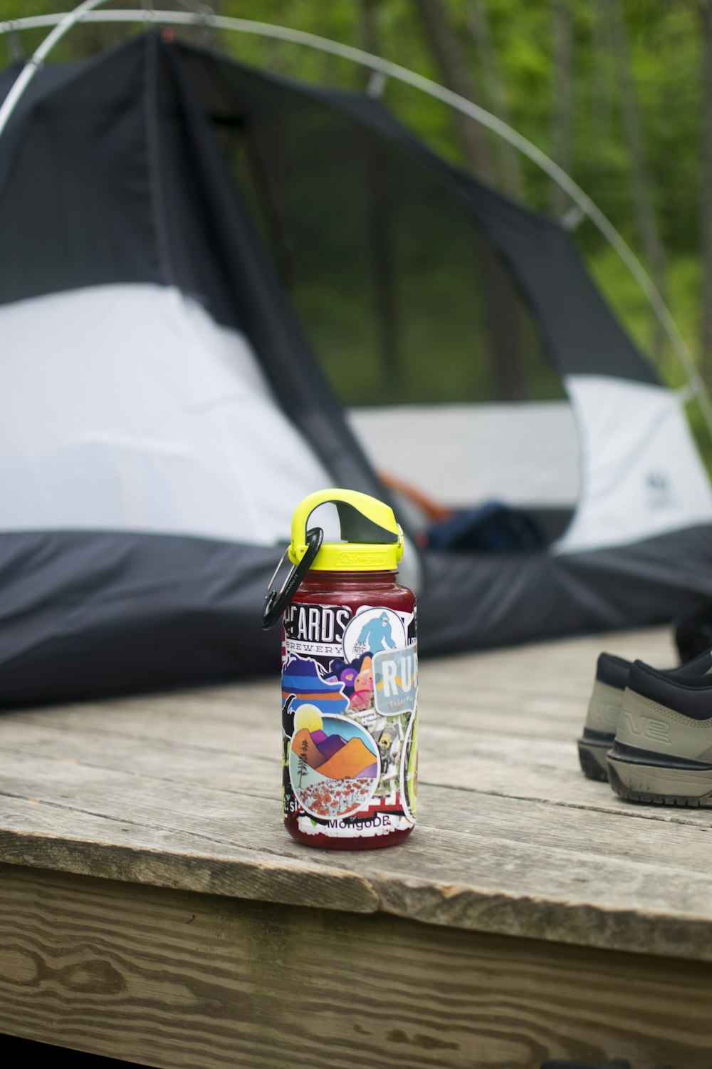 a bottle of water sitting on a table next to a tent