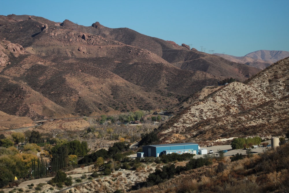 a view of a mountain range with a building in the foreground