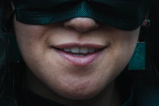 A close-up of lips with a subtle smile, hinting at untold stories.
