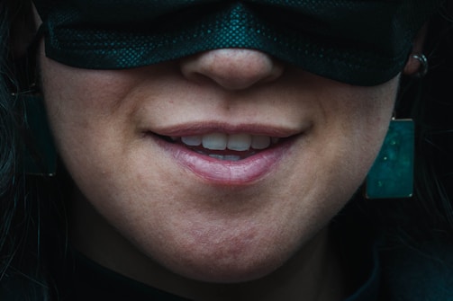 An Instagram-style snapshot of a smiling face partially hidden behind a quirky anxiety-themed mask.