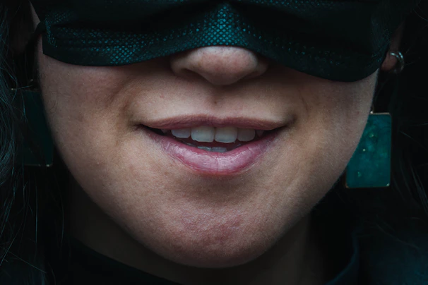 A close-up of lips with a subtle smile, hinting at untold stories.