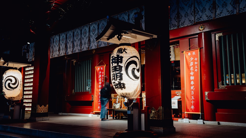 a person standing in front of a large lantern