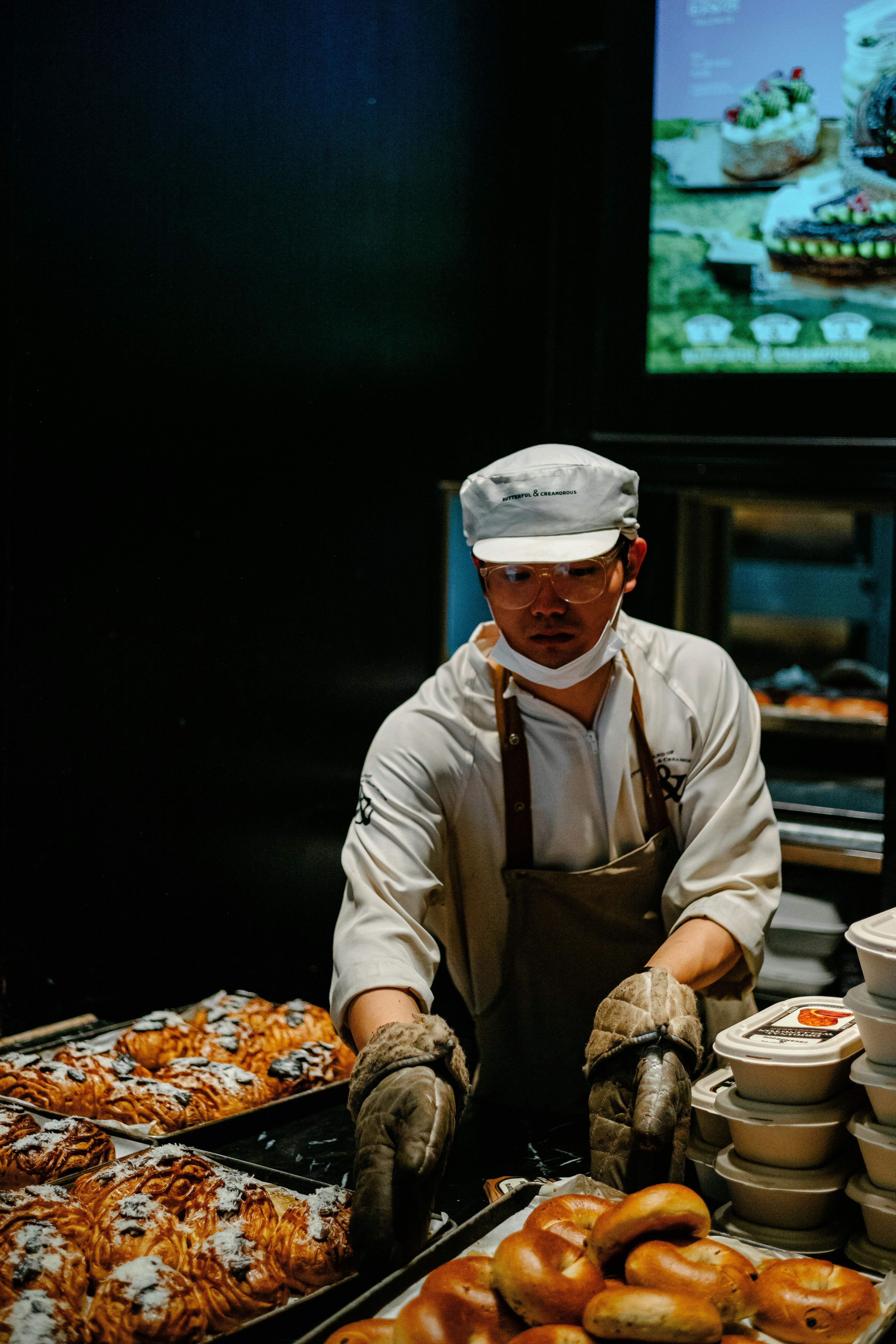 a man in a chef's hat is making doughnuts