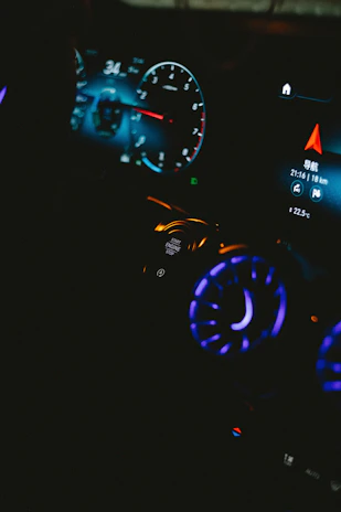 the dashboard of a car with illuminated lights