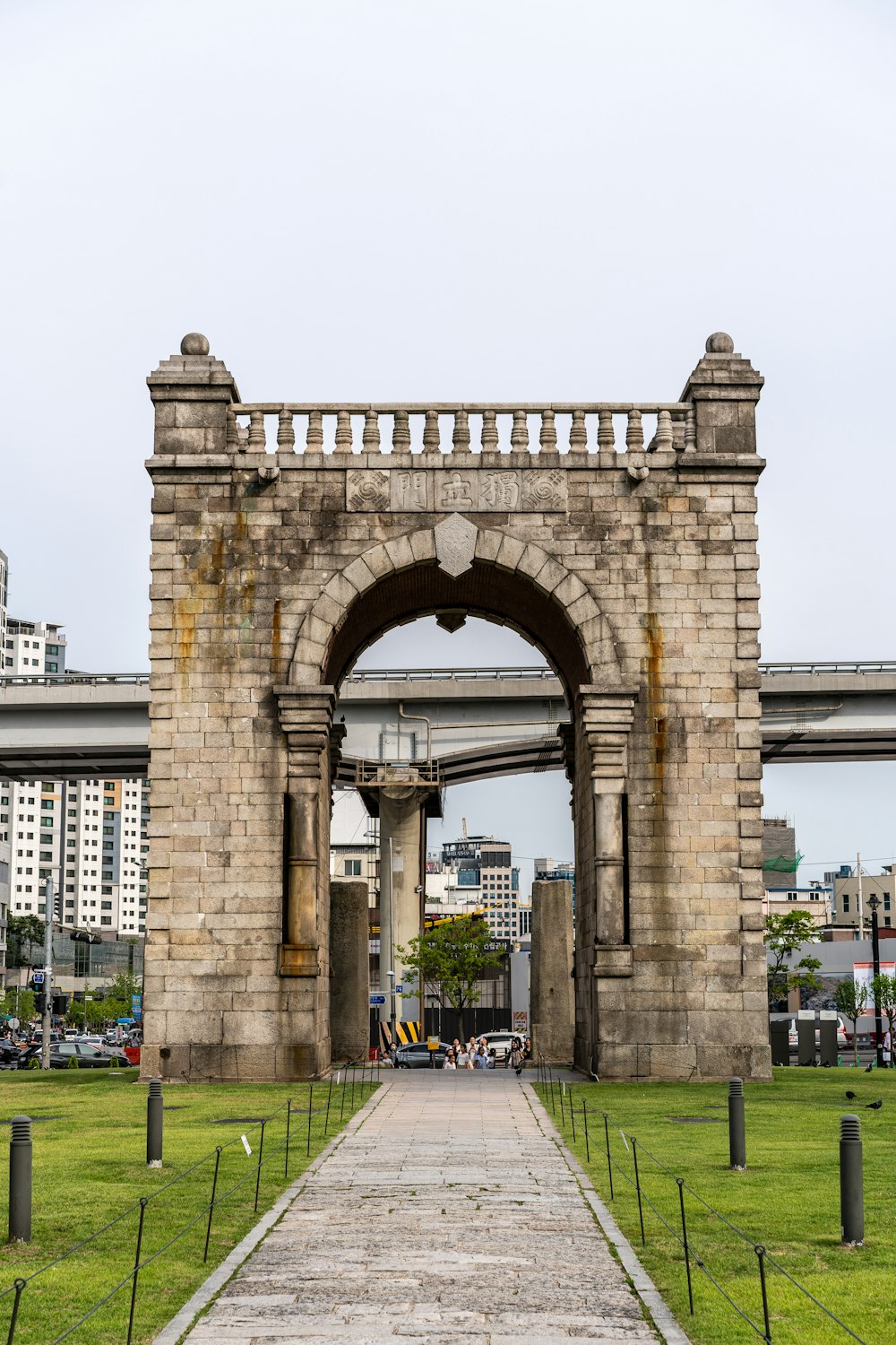 a stone gate with a walkway leading to it