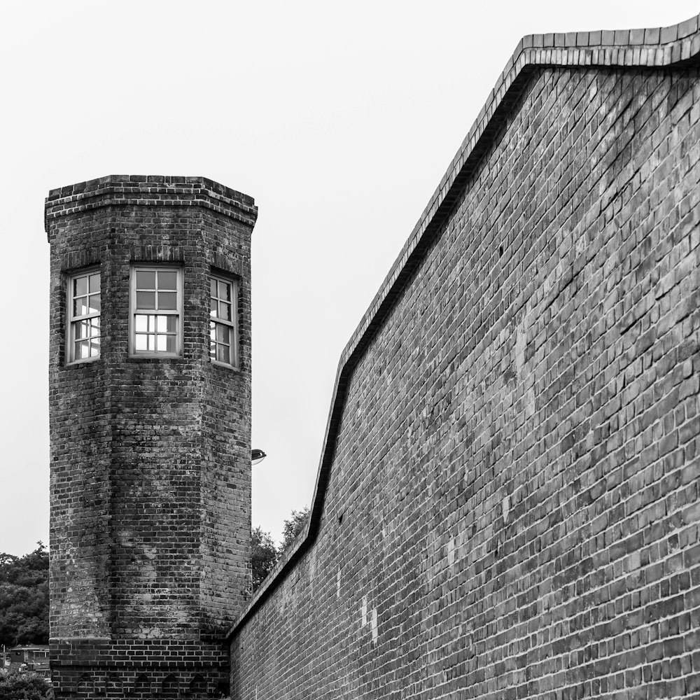 a black and white photo of a brick tower