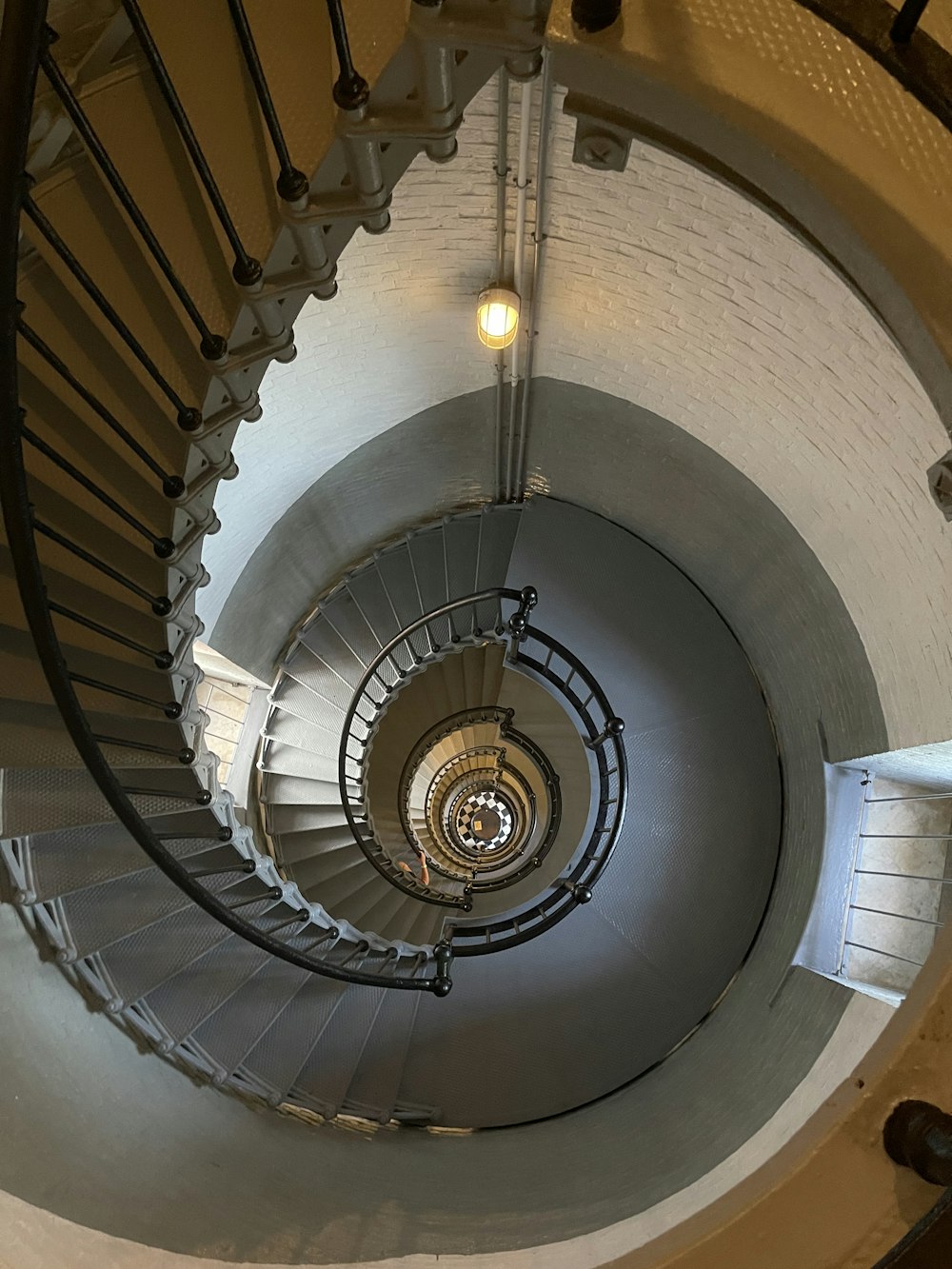 a spiral staircase in a building with a light on