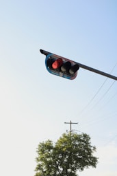 a traffic light hanging from the side of a pole